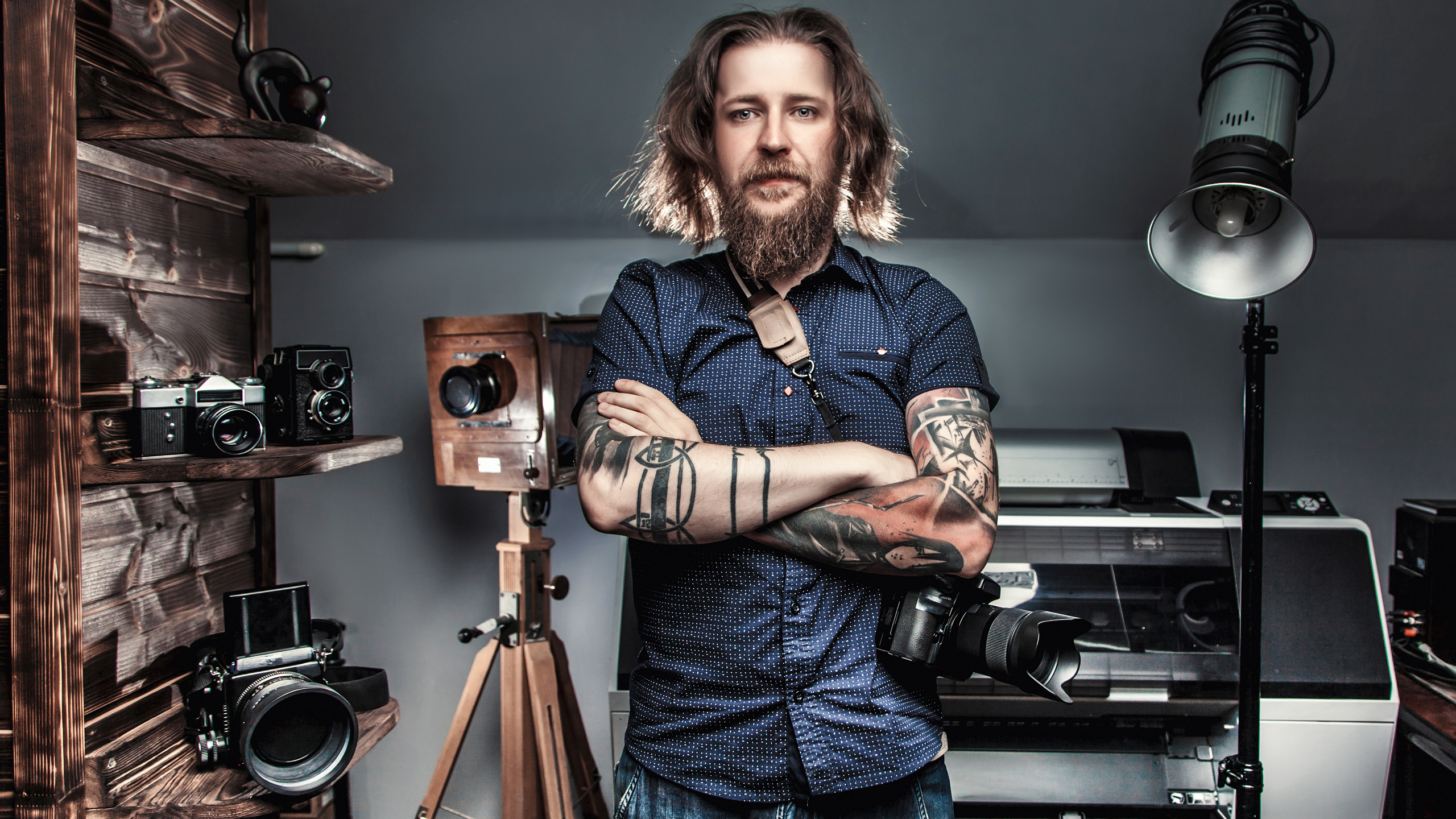Beautiful portrait of the photographer at the workplace. The con Beautiful portrait of the photographer at the workplace. The concept of the creative process, skill and favorite pastime