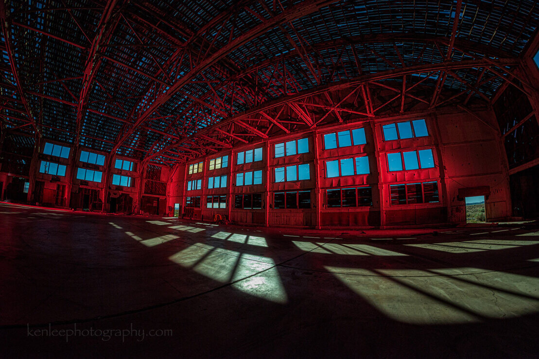 Abandoned World War II wooden hangar at night.