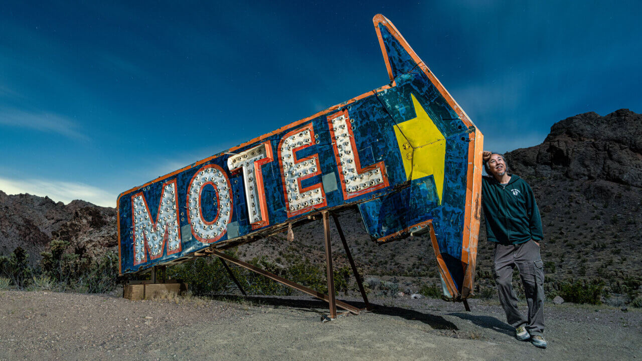 Night selfie portrait with giant motel sign